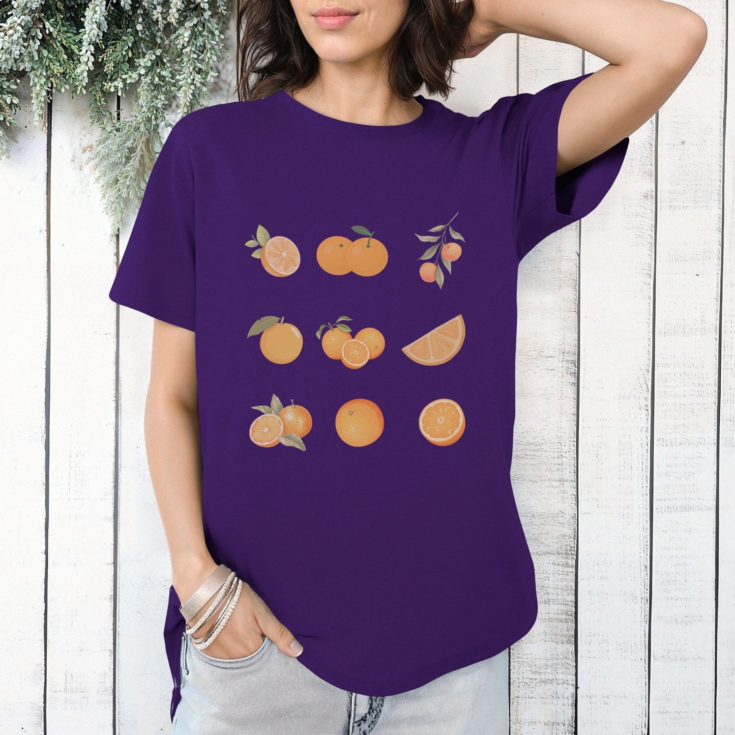 purple shirt, orange, oranges, sliced oranges, bundles of oranges, orange with leaves, cut open orange