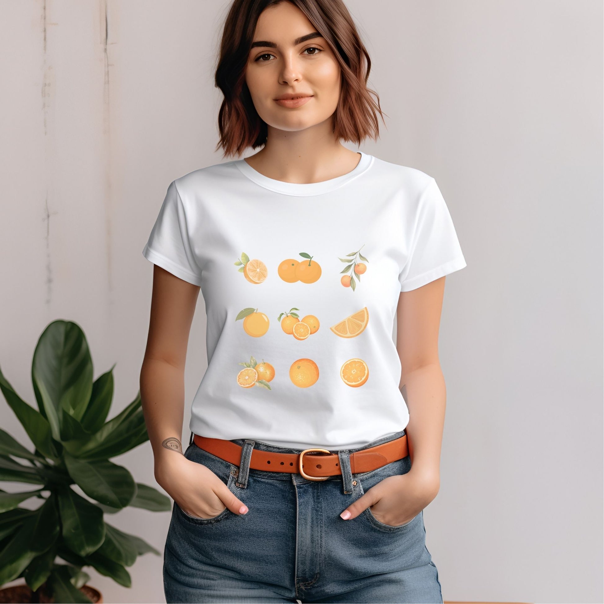 white tshirt, orange, oranges, sliced oranges, bundles of oranges, orange with leaves, cut open orange